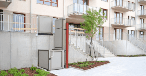 Garaventa OPAL unenclosed vertical platform lift at outdoor building entrance