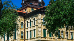 A discreet LU/LA elevator installed inside a historic North Texas building, preserving the original facade and character-defining features