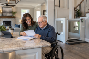 A North Texas homeowner reviewing grant and financial assistance paperwork for a home accessibility equipment installation